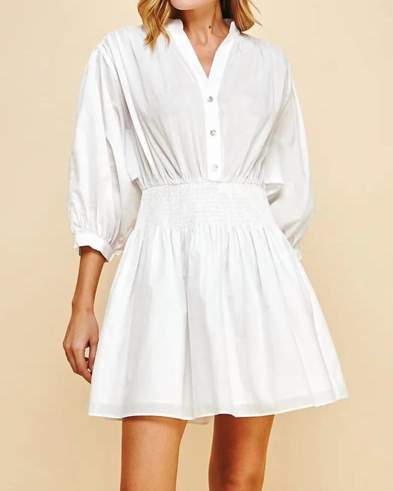 Front of a model wearing a size Large Molly Mandarin Collar Smocked Mini Dress in White in White by PINCH. | dia_product_style_image_id:335384
